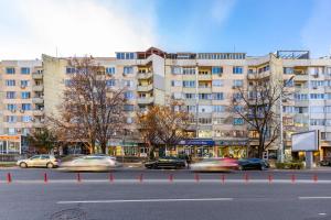 a city street with cars driving past a large building at Nikolaos Apartment by Flat Mаnager in Plovdiv