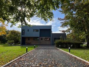 a house with a driveway in front of it at La Maison de Jane Château&Beauval in Cormeray