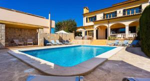 a swimming pool in front of a house at Ca Nostra in Son Servera