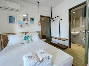 a bedroom with a bed with towels on it at Bamboo Luxury Studios in Nikiti +22 photos