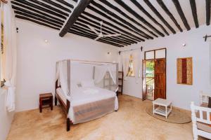 a bedroom with a bed in a room at Bwejuu Beach Duplex Bungalow in Bwejuu