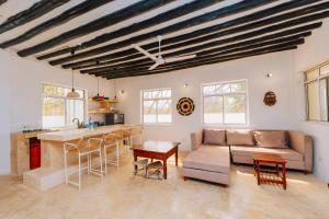 a living room with a couch and a table at Bwejuu Beach Duplex Bungalow in Bwejuu +119 photos