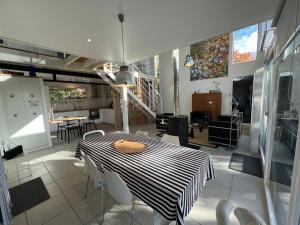 a dining room with a table and chairs at La Maison de Jane Château&Beauval in Cormeray