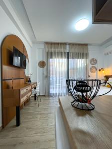 a living room with a coffee table and a couch at Bamboo Luxury Studios in Nikiti