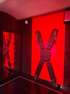 a red wall with a x sign on it at Apartament Grey in Tuchola +7 photos