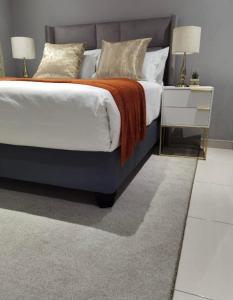 a bedroom with a large bed with a grey rug at Kings view exclusive villas in Petronella +60 photos