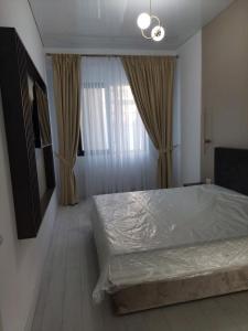 a bedroom with a large bed and a window at Costy Stefan Building 2 in Mamaia Nord