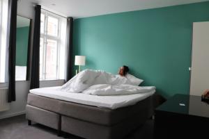 Un pat sau paturi într-o cameră la A Hotels City