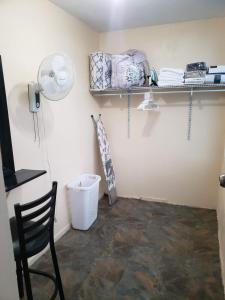 a room with a chair and a fan on a wall at West Side Studio Apartments in Anasco +28 photos