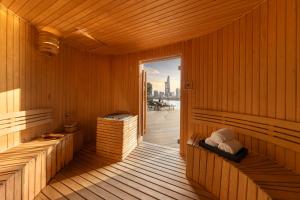 an empty sauna with a view of the city at The Metropole Opera Residence by KayStay in Ho Chi Minh City
