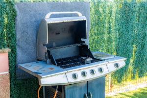 a barbecue grill sitting in front of a wall at Llac D'alcudia in Port d'Alcudia