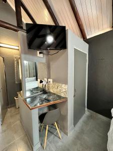 a kitchen with a counter with a sink and a chair at Ndalo Lodge Mbombela in Nelspruit