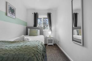 a small bedroom with a bed and a mirror at Stylish 3 Bed House, Sleeps 6, Near NEC - Airport, Parking, Contractors - Families Stay in Sheldon