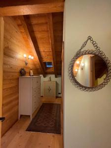 a mirror hanging on a wall in a room at Baita Lauretta in Varzo +9 photos