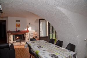 a dining room with a table and a fireplace at Gites de france 2 epis 5 personnes a mazel bouissy in Le Mazel-Bouissy