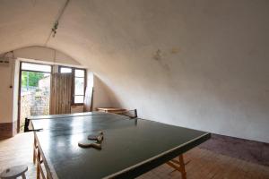 a ping pong table in an empty room with at Gites de france 2 epis 5 personnes a mazel bouissy in Le Mazel-Bouissy