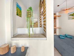 a living room with a table and a mirror at Maison charmante clim et balcon en centre ville in Marseillan +35 photos