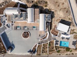 an aerial view of a building with a swimming pool at Blé Suites Santorini in Imerovigli +69 photos