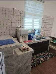 a room with a kitchen with a sink and a counter top at 4D Homestay TSNU Tampin with pool n Bbq set in Tampin +12 photos