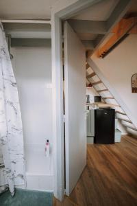 an open door in a room with a staircase at Le cocon de la gare in Rennes