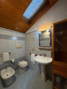 a bathroom with a sink and a toilet and a mirror at B&B Al Vecchio Molino in Valbrembo +7 photos
