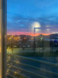 a view from a window of a city at sunset at Hotel Absolwent in Gostyń