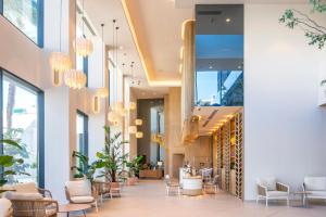 a lobby of a building with chairs and tables at Port Alicante City & Beach in Alicante