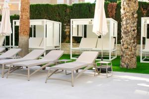 a group of chairs and umbrellas on a patio at Port Alicante City & Beach in Alicante