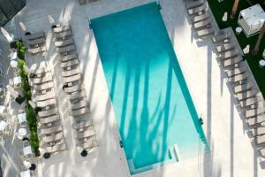 an overhead view of a swimming pool with lounge chairs at Port Alicante City & Beach in Alicante