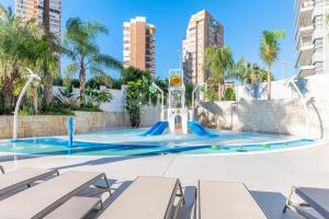 a swimming pool with a water slide in a city at Port Alicante City & Beach in Alicante