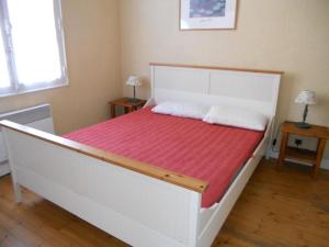 a bedroom with a white bed with a red blanket at Villa proche centre et plage - V04245 in Soulac-sur-Mer