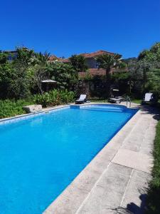 a swimming pool with blue water in a yard at Quinta de Ribas in Amarante