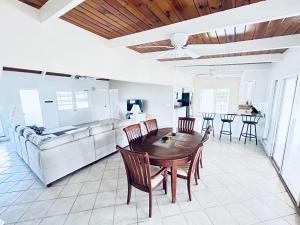 a kitchen and dining room with a table and chairs at Flamingo House - Turks & Caicos in Turtle Cove