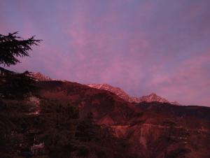 a view of a mountain range at sunset at Verma Guest House in Dharmsala
