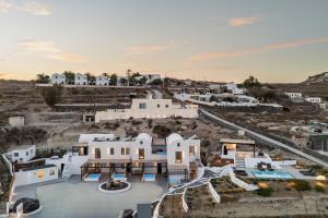 an aerial view of a white house with a pool at Blé Suites Santorini in Imerovigli
