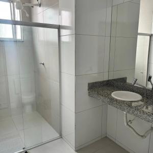 a white bathroom with a sink and a shower at Casa Marzenta in Petrolina +16 photos