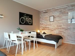 a bedroom with a bed and a table and chairs at Geräumige Handwerkerunterkunft mit Balkon in Rheine