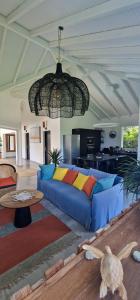 a living room with a blue couch and a table at Villa MiLouMa in Saint-François +28 photos