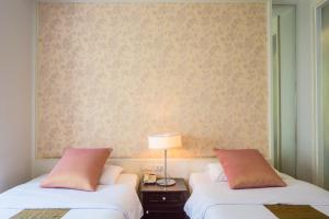 Postel nebo postele na pokoji v ubytování Aphrodite Inn Bangkok