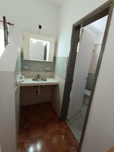 a bathroom with a sink and a mirror at Alojamiento Esparta in Villa Carlos Paz