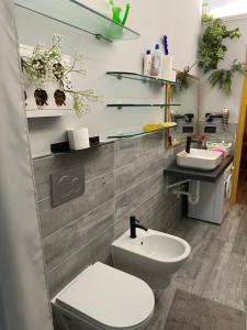 a bathroom with a toilet and a sink at Pinerolo medievale in Pinerolo +18 photos