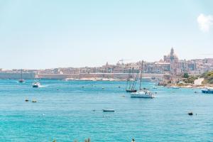 a large body of water with boats in it at The Strand Waterfront Apartment with 3 Bedrooms, 4 Bathrooms, Private Garage in Sliema +28 photos