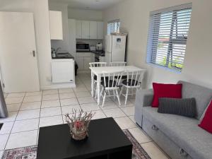 a living room with a couch and a table at Plett's Life in Plettenberg Bay