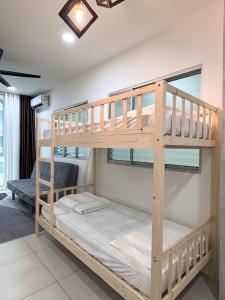 a bedroom with two bunk beds in a room at MetroCity Square Condominium-3R2B-9 Pax in Kuching