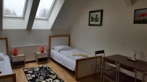 sypialnia z łóżkiem i biurkiem oraz 2 oknami w obiekcie Farm Stay NH Stables w mieście Nýřany