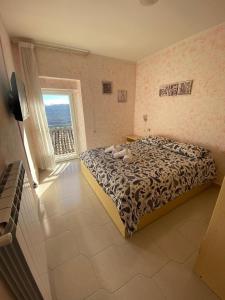 a bedroom with a bed and a large window at Don Pasquale Scontrone House in Scontrone +51 photos