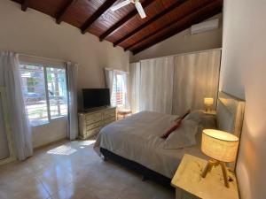 a bedroom with a bed and a television in it at Casa Quinta Guacaras in Santa Ana +27 photos