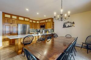 a large kitchen with a wooden table and chairs at Jay Peak Village Home 375 in Jay