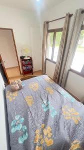 a bedroom with a bed with a blue comforter at Casa Doña Elsa - amoblada ideal descanso en Volcán - Jujuy in Volcán +14 photos