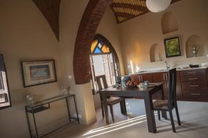 a kitchen with a table and chairs and a table and a window at Laziza in Luxor